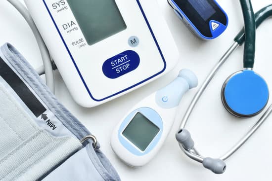 Blood pressure monitor, thermometer, and stethoscope laid out ready for use